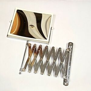 Retractable chrome magnifying mirror